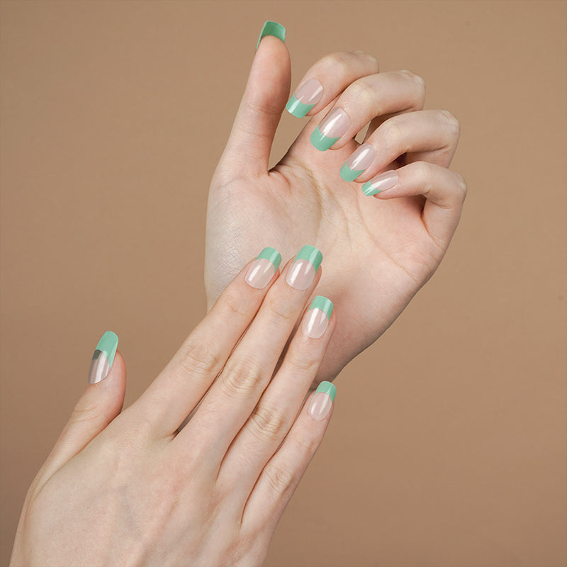 Modern teal French tip nails on hands, created with a DIY semi-cured gel sticker kit for a bold, sophisticated twist on a classic manicure.