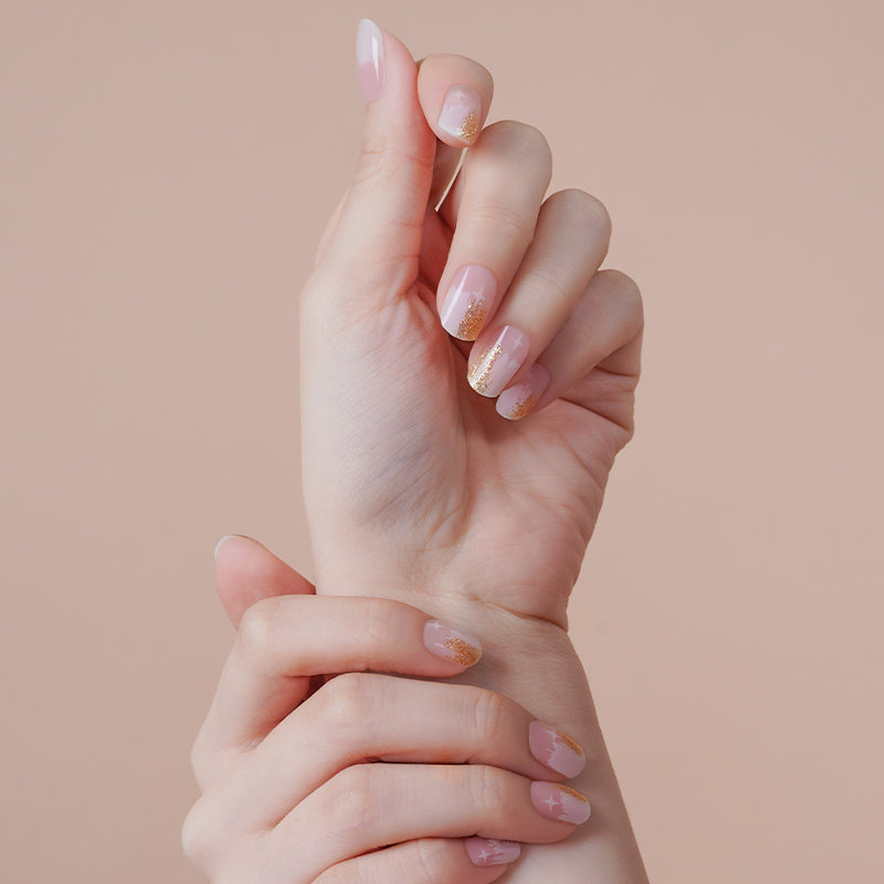 Celestial white vanilla star nails on hands, achieved with a DIY semi-cured gel sticker kit for a magical, whimsical manicure.